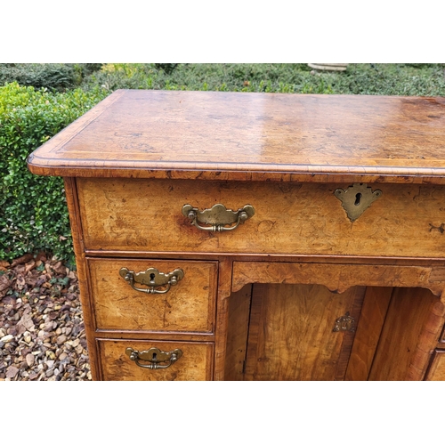 305 - AN 18TH CENTURY BURR WALNUT KNEEHOLE DESK
With an arrangement of seven drawers and central cupboard,... 