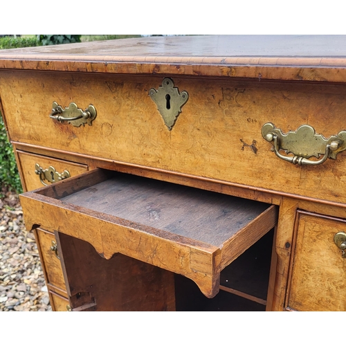 305 - AN 18TH CENTURY BURR WALNUT KNEEHOLE DESK
With an arrangement of seven drawers and central cupboard,... 