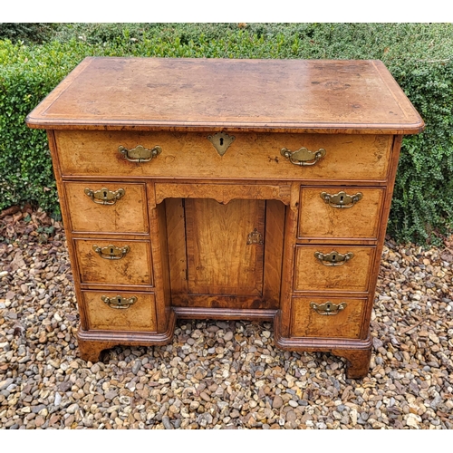 305 - AN 18TH CENTURY BURR WALNUT KNEEHOLE DESK
With an arrangement of seven drawers and central cupboard,... 