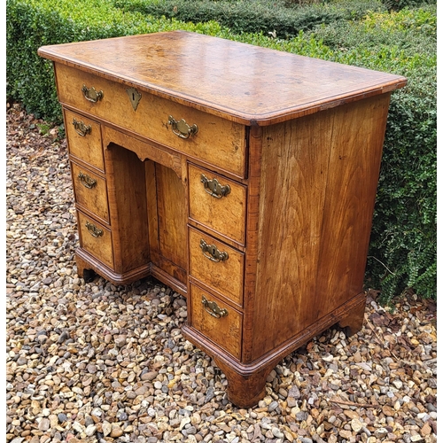 305 - AN 18TH CENTURY BURR WALNUT KNEEHOLE DESK
With an arrangement of seven drawers and central cupboard,... 