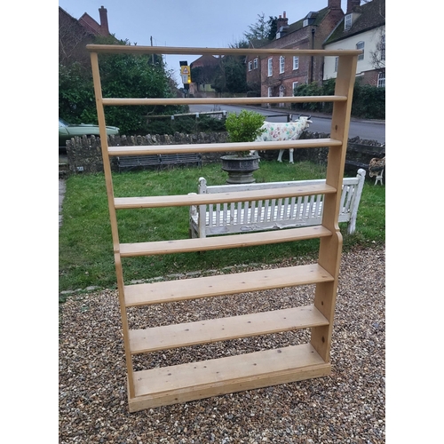 306 - A 19TH CENTURY PINE FLOOR STANDING WATERFALL BOOKCASE
With seven narrow shelves, on a plinth base.
(... 