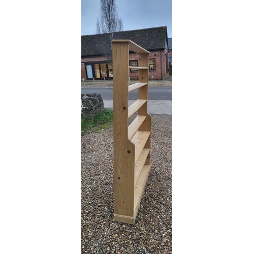 306 - A 19TH CENTURY PINE FLOOR STANDING WATERFALL BOOKCASE
With seven narrow shelves, on a plinth base.
(... 