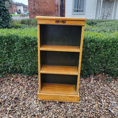 308 - A FAUX SATINWOOD PAINTED FLOOR STANDING OPEN BOOKCASE 
Along with a mahogany bedside cabinet, a maho... 