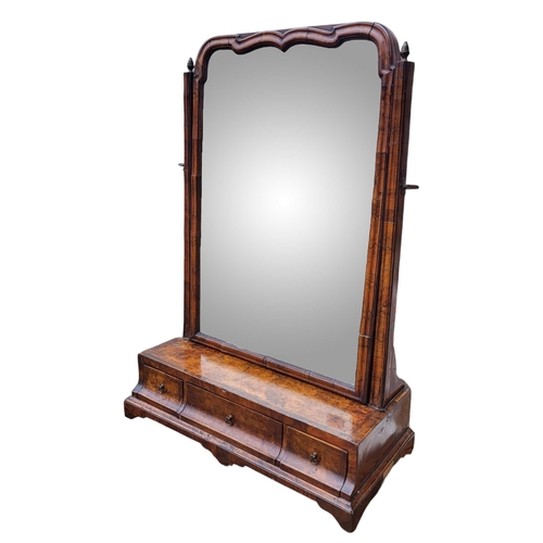 311 - AN 18TH CENTURY WALNUT TOILET MIRROR
With serpentine planished bevelled above three trinket drawers,... 