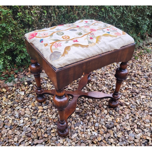 313 - AN 18TH/19TH CENTURY QUEEN ANNE STOOL
With crewel work cover, above solid apron, raised on four cup ... 