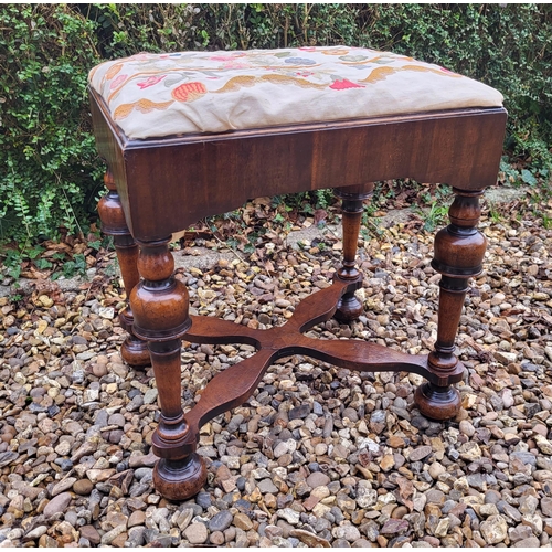 313 - AN 18TH/19TH CENTURY QUEEN ANNE STOOL
With crewel work cover, above solid apron, raised on four cup ... 