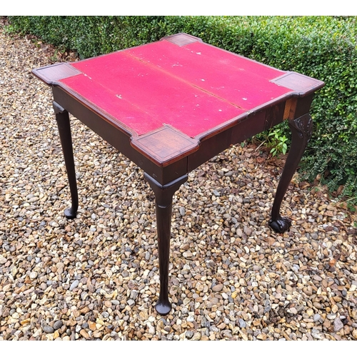 315 - AN 18TH CENTURY MAHOGANY FOLD OVER CARD TABLE
With inverted break front top, enclosing red baize sur... 