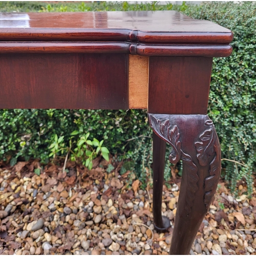 315 - AN 18TH CENTURY MAHOGANY FOLD OVER CARD TABLE
With inverted break front top, enclosing red baize sur... 