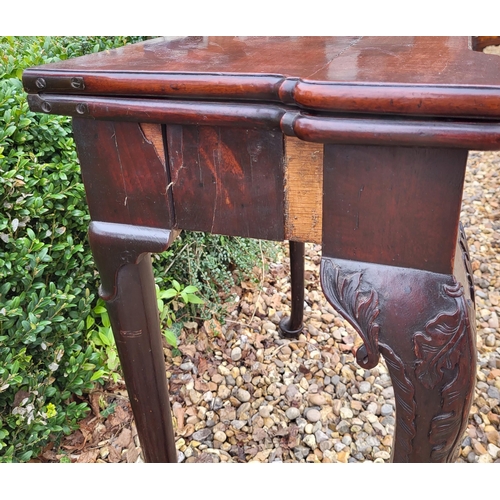 315 - AN 18TH CENTURY MAHOGANY FOLD OVER CARD TABLE
With inverted break front top, enclosing red baize sur... 