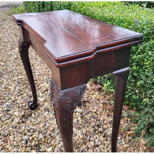 315 - AN 18TH CENTURY MAHOGANY FOLD OVER CARD TABLE
With inverted break front top, enclosing red baize sur... 