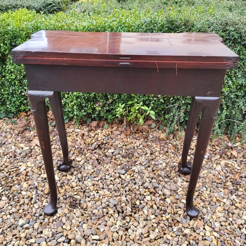 315 - AN 18TH CENTURY MAHOGANY FOLD OVER CARD TABLE
With inverted break front top, enclosing red baize sur... 