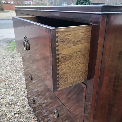 318 - A 19TH CENTURY MAHOGANY CHEST
With two short and three long drawers with brass handles, on bracket f... 