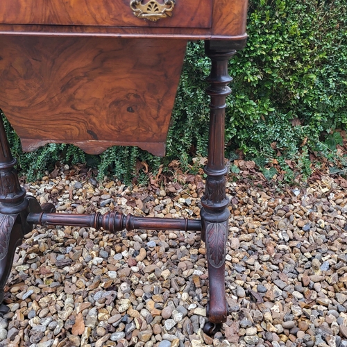 320 - A VICTORIAN WALNUT LADIES’ WORK TABLE
With single drawer and basket, on acanthus carved turned suppo... 