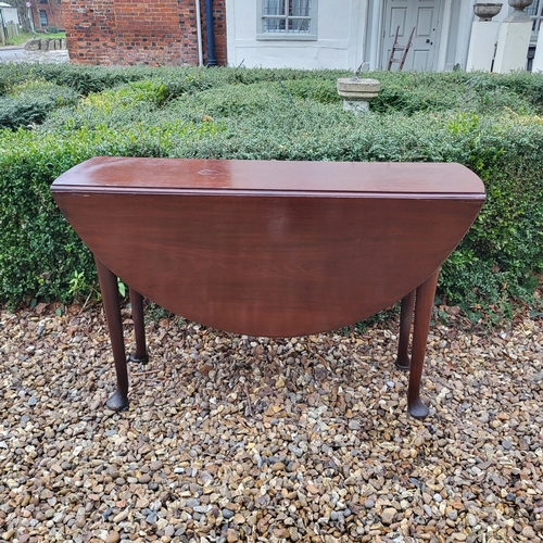 334 - A 19TH CENTURY SOLID MAHOGANY CIRCULAR DROP LEAF TABLE
On turned legs with pad feet.
(110cm x d 35cm... 