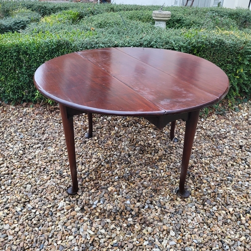 334 - A 19TH CENTURY SOLID MAHOGANY CIRCULAR DROP LEAF TABLE
On turned legs with pad feet.
(110cm x d 35cm... 