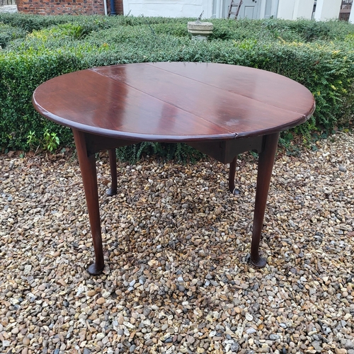 334 - A 19TH CENTURY SOLID MAHOGANY CIRCULAR DROP LEAF TABLE
On turned legs with pad feet.
(110cm x d 35cm... 