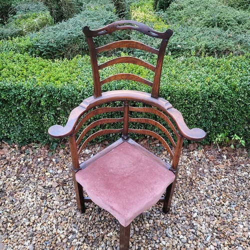 335 - A 19TH CENTURY ELM LADDER BACK CORNER CHAIR
With pierced serpentine top rail, overstuffed upholstere... 