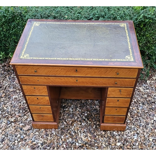 336 - A 19TH CENTURY MAHOGANY AND SATINWOOD KNEEHOLE DESK
With tooled leather writing surface above an arr... 