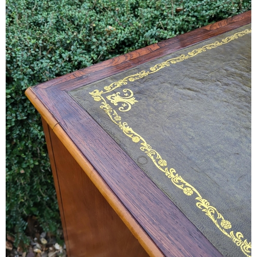 336 - A 19TH CENTURY MAHOGANY AND SATINWOOD KNEEHOLE DESK
With tooled leather writing surface above an arr... 