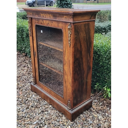 339 - A HIGH VICTORIAN FIGURED WALNUT AND MARQUETRY INLAID PIER CABINET
The single glazed door enclosing a... 