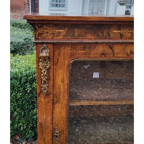 339 - A HIGH VICTORIAN FIGURED WALNUT AND MARQUETRY INLAID PIER CABINET
The single glazed door enclosing a... 