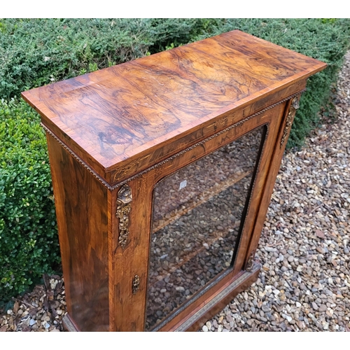 339 - A HIGH VICTORIAN FIGURED WALNUT AND MARQUETRY INLAID PIER CABINET
The single glazed door enclosing a... 