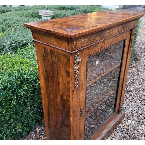 339 - A HIGH VICTORIAN FIGURED WALNUT AND MARQUETRY INLAID PIER CABINET
The single glazed door enclosing a... 