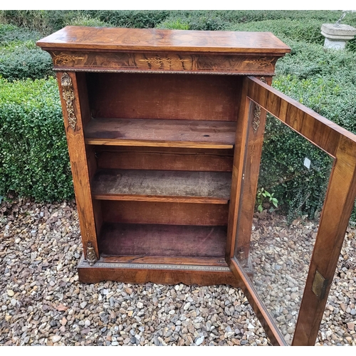 339 - A HIGH VICTORIAN FIGURED WALNUT AND MARQUETRY INLAID PIER CABINET
The single glazed door enclosing a... 