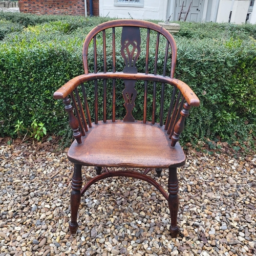 344 - A 19TH CENTURY YEW AND ELM WINDSOR CHAIR
With pierced splat back, elm seat and crinoline stretcher, ... 