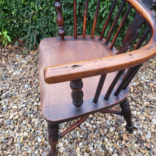 344 - A 19TH CENTURY YEW AND ELM WINDSOR CHAIR
With pierced splat back, elm seat and crinoline stretcher, ... 