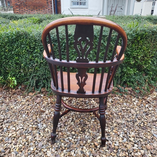 344 - A 19TH CENTURY YEW AND ELM WINDSOR CHAIR
With pierced splat back, elm seat and crinoline stretcher, ... 