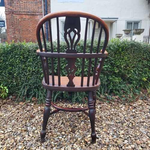 344 - A 19TH CENTURY YEW AND ELM WINDSOR CHAIR
With pierced splat back, elm seat and crinoline stretcher, ... 