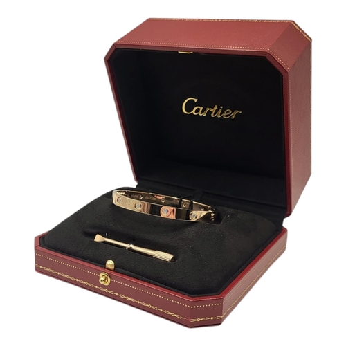 80 - CARTIER, AN 18CT GOLD AND DIAMOND LOVE BANGLE
Set with ten round cut diamonds and screw head clasp, ... 