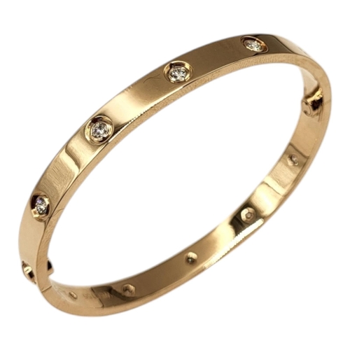 80 - CARTIER, AN 18CT GOLD AND DIAMOND LOVE BANGLE
Set with ten round cut diamonds and screw head clasp, ... 