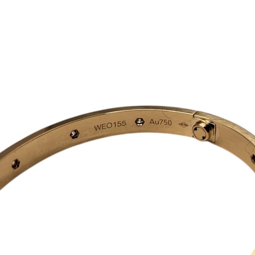 80 - CARTIER, AN 18CT GOLD AND DIAMOND LOVE BANGLE
Set with ten round cut diamonds and screw head clasp, ... 