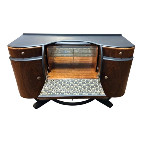 357 - AN ART DECO STYLE ‘BEAUTILITY’ COCKTAIL CABINET
The shaped top above a central sliding illuminated s... 