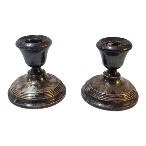 82 - A PAIR OF MID CENTURY SILVER CANDLESTICKS
Squat form, with engraved inscription ’Til Mossi fra Tytte... 