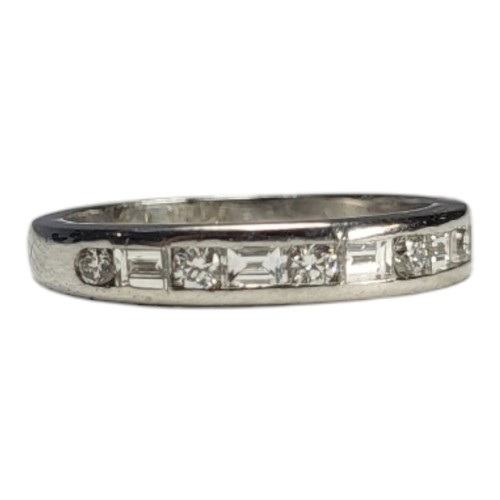 77 - TIFFANY AND CO., A PLATINUM .950 HALF ETERNITY RING
Set with baguette and round brilliant cut diamon... 