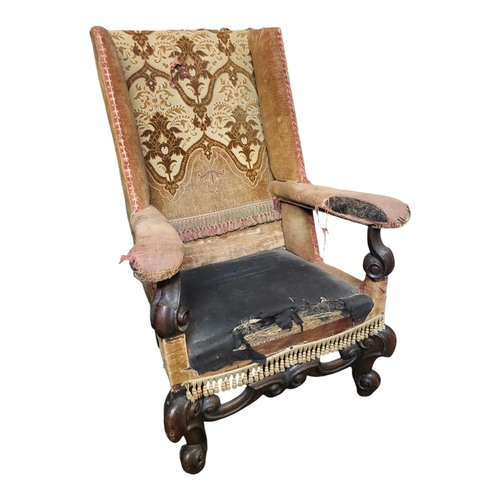 361 - AN ANTIQUE BAROQUE STYLE  WALNUT FRAMED SLEEPING WING ARMCHAIR
In later fabric upholstery.
(w 64cm x... 