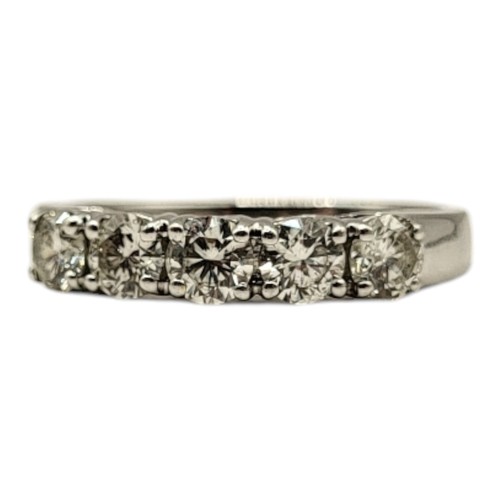 83 - AN 18CT WHITE GOLD AND DIAMOND FIVE STONE RING
The row of round cut diamonds set in a plain design, ... 