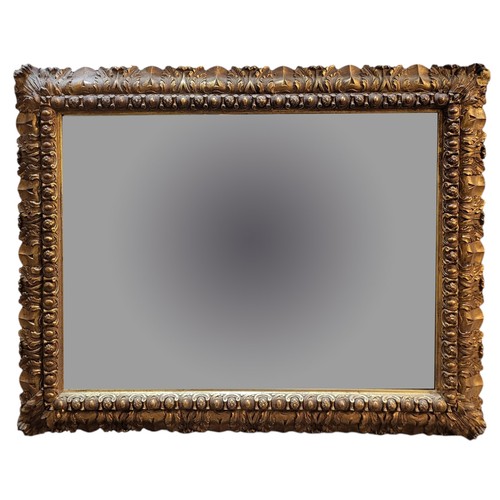 213 - AN EARLY 20TH CENTURY GILDED WOOD GESSO CONTINENTAL RECTANGULAR WALL MIRROR, CIRCA 1900
Bevelled pla... 