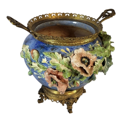 103 - A 19TH CENTURY FAIENCE POTTERY AND GILT BRASS JARDINIERE
Twin handles with pierced gallery rim and m... 