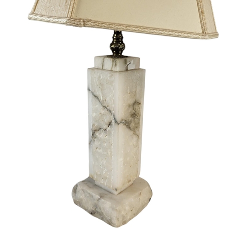 105 - A MID CENTURY CARVED ALABASTER LAMP
Rectangular form with carved decoration, fabric shade and square... 