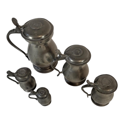 116 - A SET OF FIVE VICTORIAN PEWTER LIDDED TANKARDS
Graduated set with shell form thumb piece, embossed i... 