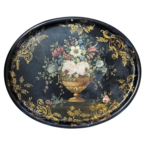 176 - A VICTORIAN PAPIER-MACHE TRAY
Decorated with floral bouquets within a gilded cartouche border, along... 