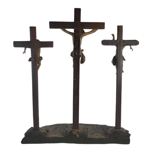 188 - A 19TH CENTURY CARVED WOOD AND POLYCHROME GROUP CRUCIFIXION SCENE
Central figure of Christ flanked b... 