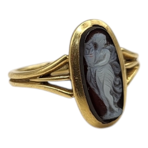 25 - A VICTORIAN 18CT GOLD AND SARDONYX CAMEO RING
Oval carved classical figural cameo on a pierced mount... 