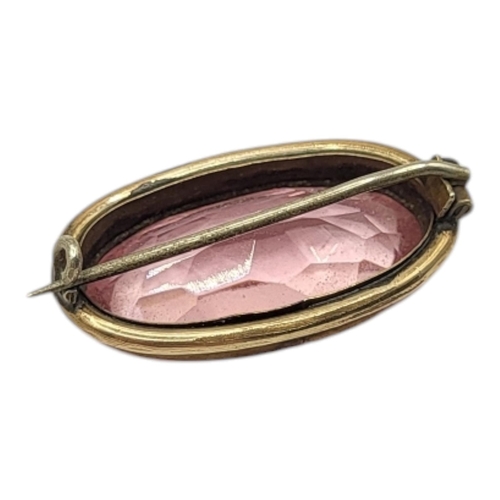 26 - A VICTORIAN YELLOW METAL AND ROSE QUARTZ BROOCH
Oval cut stone, with beaded edge mount.
(approx 3cm)... 