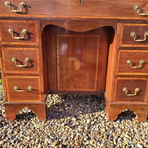 353 - A LATE VICTORIAN MAHOGANY AND SHELL INLAID SHERATON INSPIRED KNEEHOLE DESK
With an arrangement of se... 