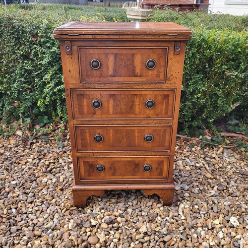 355 - A REGENCY STYLE YEW PEDESTAL CHEST
The fold over top with green tooled leather writing surface above... 